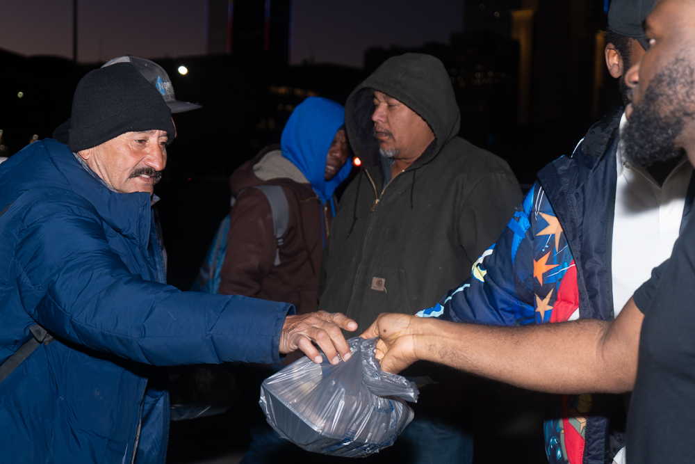 Volunteers distributing food packages to families